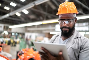 man using tablet in a factory