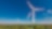 Ein Windrad steht in einem Feld.
