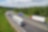 Mehrere Lkw fahren auf einer Landstraße