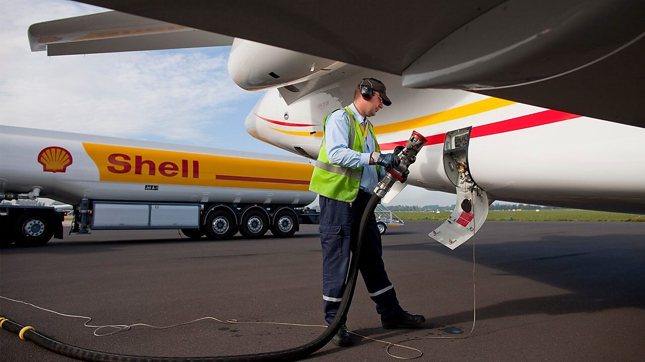shell employee is fueling up airplane