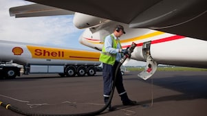 shell employee is fueling up airplane