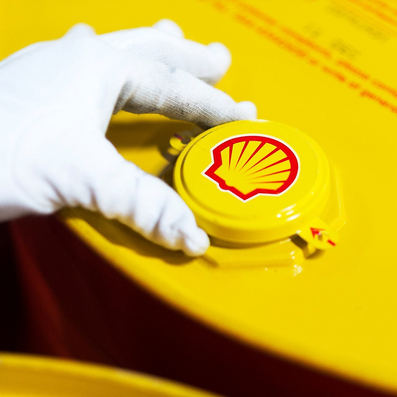 Employee closing a freshly filled drum at the filling line at Taloja lubricants-oil plant