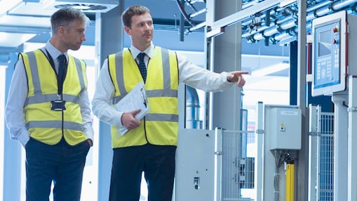 Two engineers walking around the factory