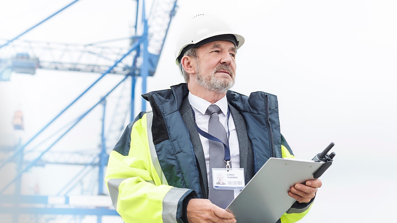 man standing with file in hand