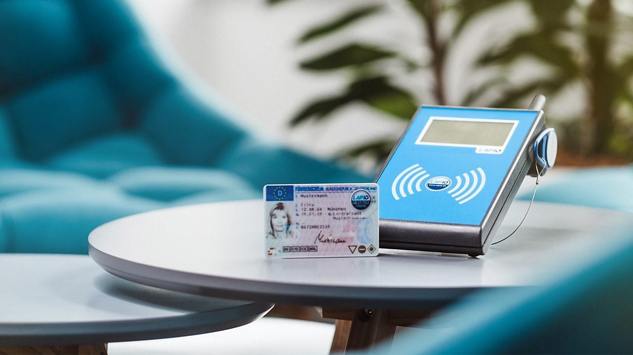 a lapid terminal with a drivers license is on a table