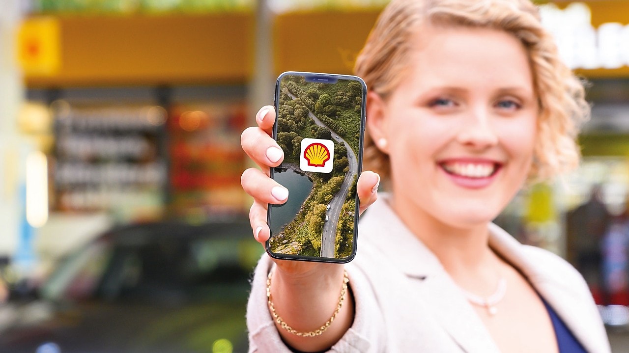 women showing shell on mobile