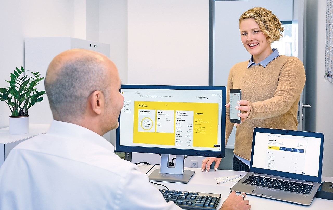 One employee showing something on mobile to other employee