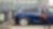 Employee standing in front of electric company car