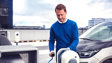 Der Fahrer lädt sein E-Fahrzeug an einer E-Mobility Ladestation.